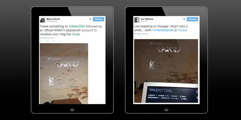 Two tablets side-by-side displaying Twitter posts on a dark background. The left screen shows a tweet by Marco Ferrari explaining how to interact with the art installation, while the right screen shows a tweet by Ivor Williams about live tweeting to Voyager 1, both accompanied by photos of the installation.