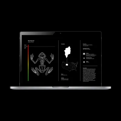 Laptop showing the companion app species detail page for the Wyoming Toad (Anaxyrus baxteri), with a white skeletal illustration, an “Extinct in the wild” status bar in red, a US map highlighting Wyoming, and species data including taxonomy, threats, and description.