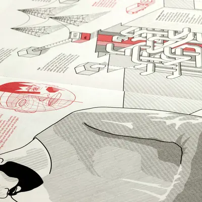 Close-up of printed Anonymity and Camouflage atlas spreads layered together, showing isometric labyrinth and network diagrams in red and black, a red wireframe face illustration, and a large illustrated figure in the foreground.