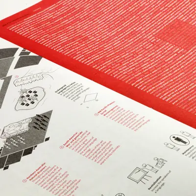 Close-up of the printed Languages atlas spread, showing a dense red full-bleed text page overlapping white pages with isometric diagrams, endangered language maps, and data panels on causes of language loss and revitalisation.